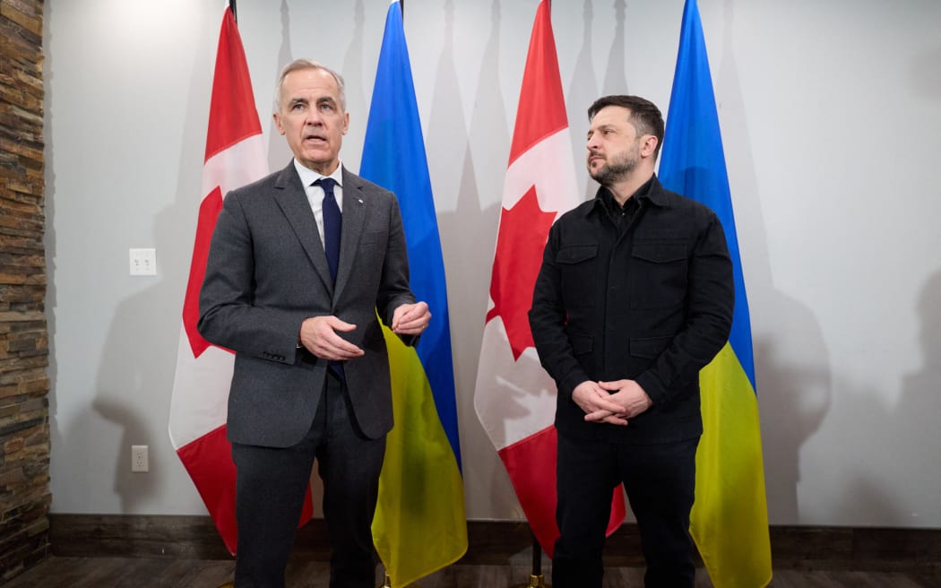 This handout photograph taken on December 27, 2025 and released by the Ukrainian Presidential Office shows Ukraine's President Volodymyr Zelensky (R) and Canadian Prime Minister Mark Carney speaking to the press as they meet in Halifax, Nova Scotia, Canada. Establishing a lasting peace in Ukraine requires "a willing Russia," Carney said Saturday, denouncing the "barbarism" of Moscow's latest bombardment of Kyiv as he met with Zelensky. (Photo by HANDOUT / UKRAINIAN PRESIDENTIAL OFFICE / AFP) / RESTRICTED TO EDITORIAL USE - MANDATORY CREDIT "AFP PHOTO /  UKRAINIAN PRESIDENTIAL OFFICE / HANDOUT" - HANDOUT - NO MARKETING NO ADVERTISING CAMPAIGNS - DISTRIBUTED AS A SERVICE TO CLIENTS