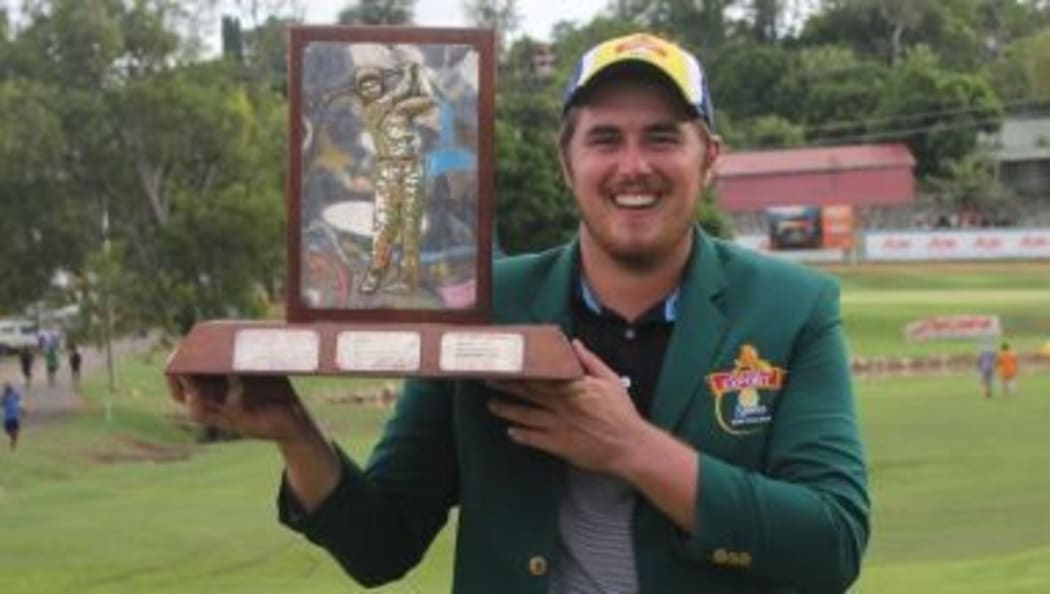Brad Moules holds aloft the PNG Open trophy.