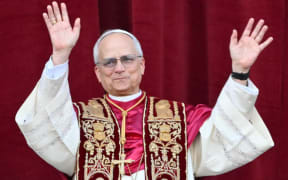 Newly elected Pope Leo XIV, Robert Prevost arrives on the main central loggia balcony of the St Peter's Basilica for the first time, after the cardinals ended the conclave, in The Vatican, on May 8, 2025. Robert Francis Prevost was on Thursday elected the first pope from the United States, the Vatican announced. A moderate who was close to Pope Francis and spent years as a missionary in Peru, he becomes the Catholic Church's 267th pontiff, taking the papal name Leo XIV. (Photo by Alberto PIZZOLI / AFP)