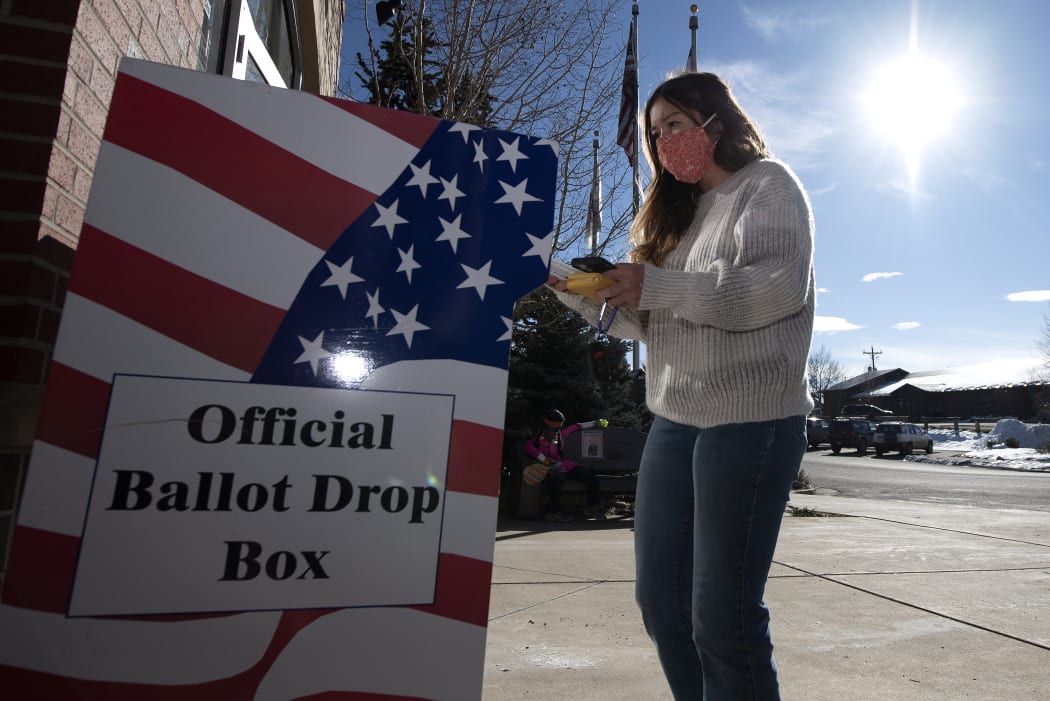 A voter drops of her ballot at the Granby Town Hall  in Granby, Colorado on November 3, 2020.