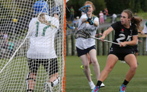 New Zealand's Megan Archer scores a goal past Australia's Madeleine Russell during a women's international Lacrosse match.