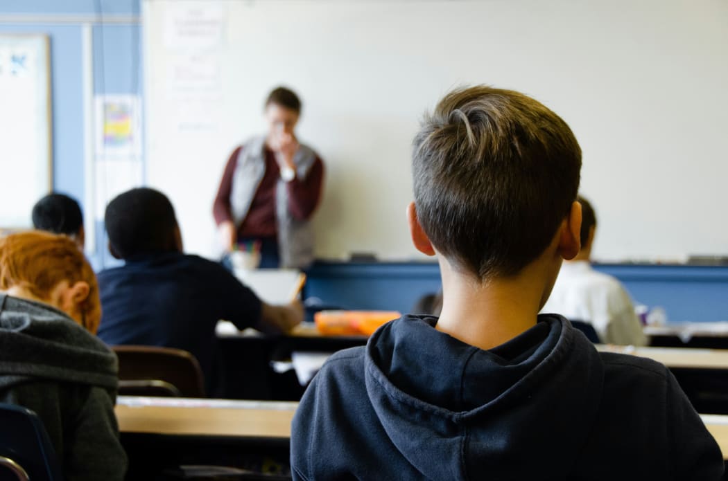 Students learning in a school classroom.