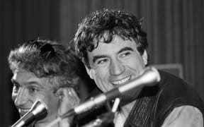 Monty Python star and film director Terry Jones, right, speaks to meda about his film "The Meaning of Life" at the Cannes film festival, 1983.