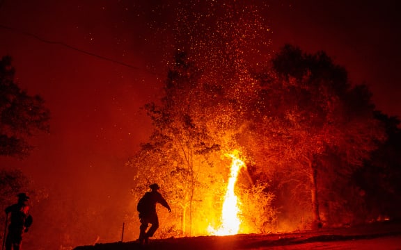 Firefighters monitor a backfire during the Carr fire in Redding, California
