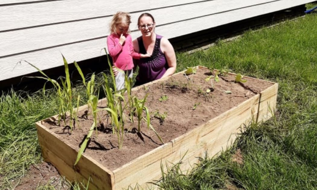 Patricia and her daughter with their new raised garden bed.