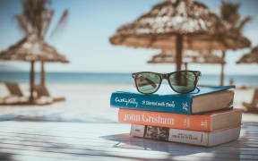 A stack of books on a table at an island resort