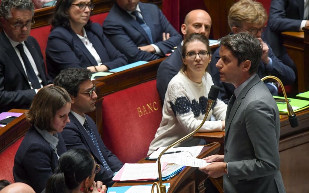 France's Prime Minister Gabriel Attal delivers a speech on the death of the two prison guards killed in an ambush at the Incarville toll station (Eure) after a minute of silence to pay their respect, before a session of questions, in Paris, on May 14, 2024. Two prison officers were killed and three seriously injured at the Incarville toll station (Eure) during the violent attack on their van transporting an escaped prisoner between Evreux and Rouen, on May 14, 2024. (Photo by Mehdi FEDOUACH / AFP)