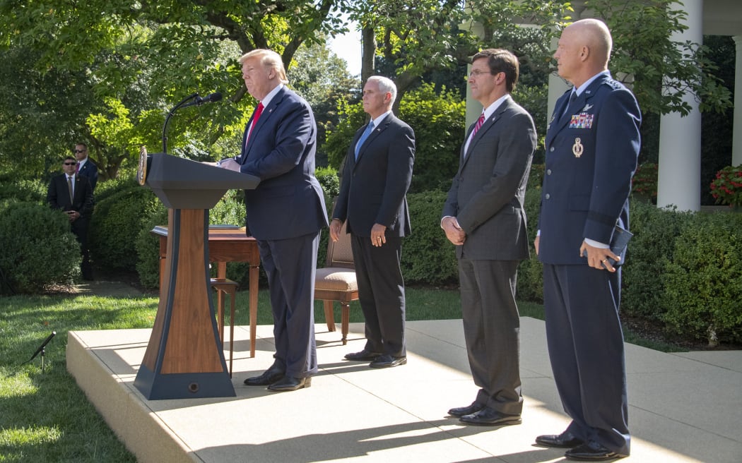 United States President Donald J. Trump, left, makes remarks establishing the US Space Command in the Rose Garden of the White House in Washington, DC on Thursday, August 29, 2019.
