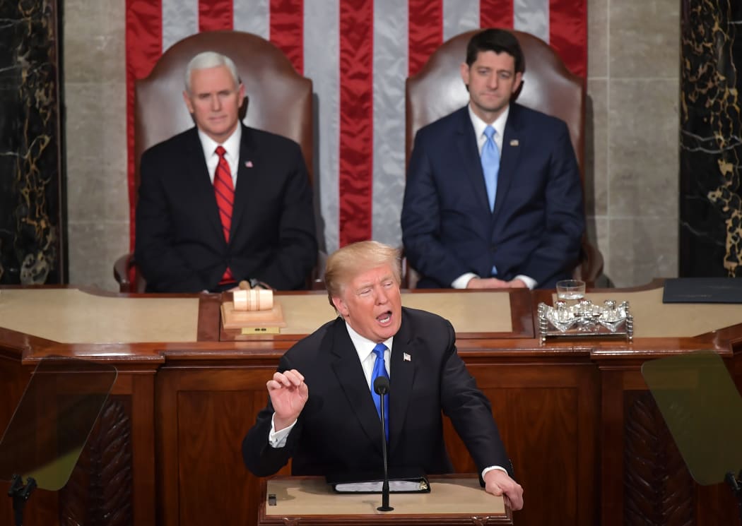 US Vice President Mike Pence (L) and Speaker of the House Paul Ryan listen as US President Donald Trump gives his State of the Union address.