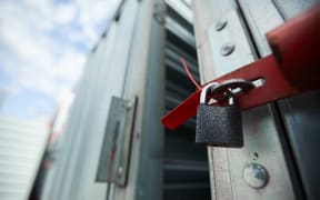 Close-up of closed cargo container on lock, sealed container in warehouse area