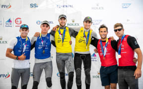 Isaac McHardie and William McKenzie (L) win silver, David and Lachy Gilmour (C) win gold, Blair Tuke and Peter Burley (R) win bronze in the 49er