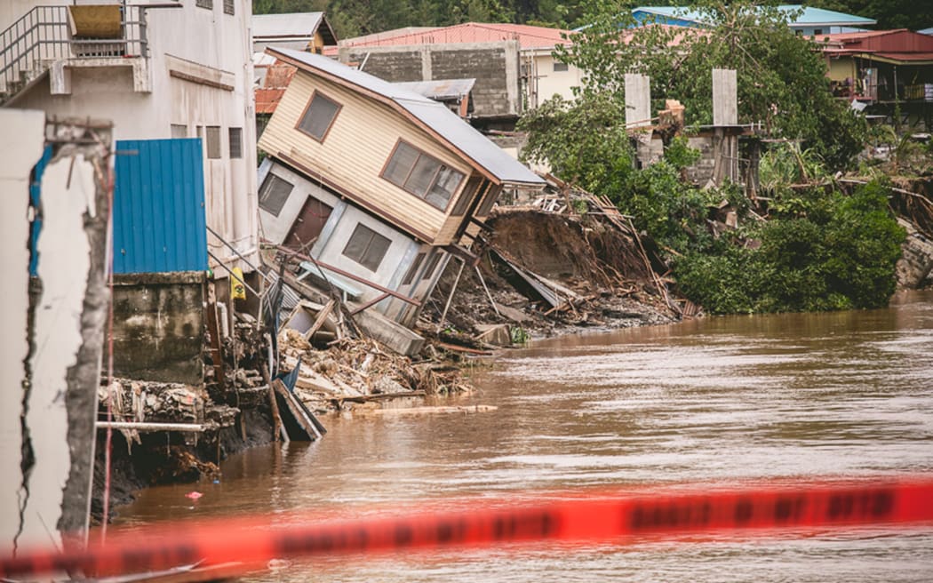 Houses partially washed away on the Mataniko River.