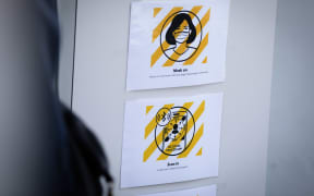 A sign of Covid safety procedures outside a business