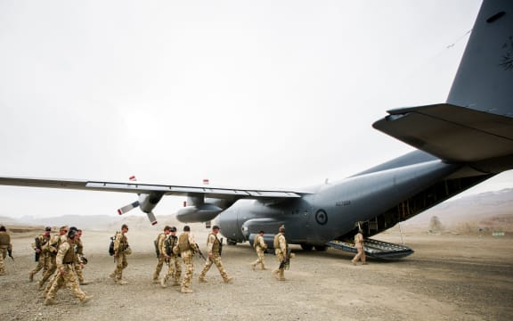 NZ Defence Force personnel boarding a Hercules plane.