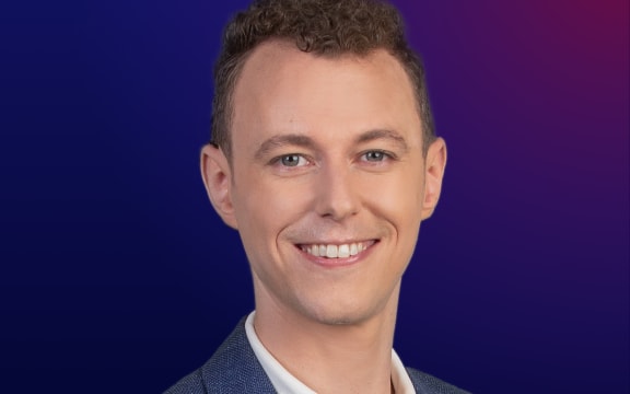 A smiling man (Emile Donovan) with short brown hair wearing a white top and a casual blue jacket. Text reads "Nights" .  Dark blue background.