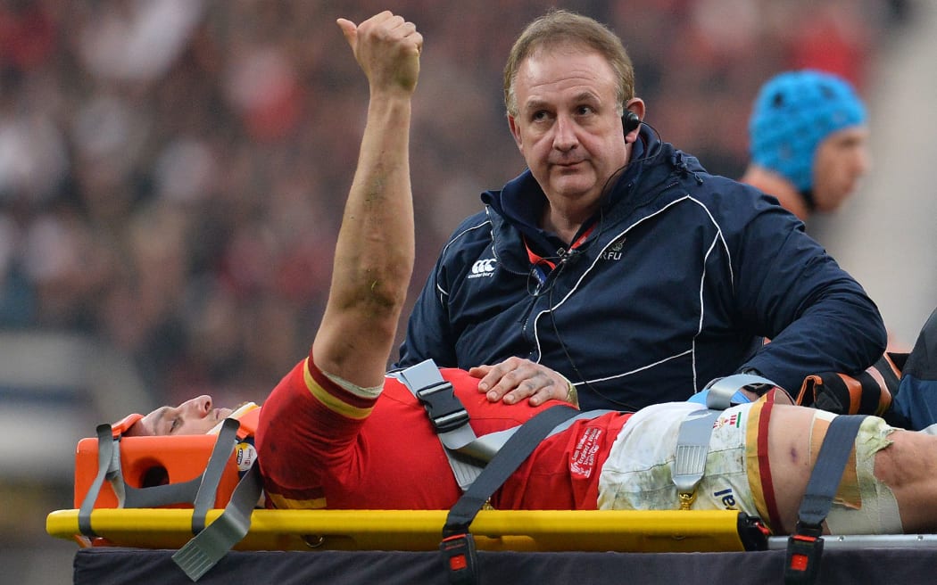 Wales captain Sam Warburton shows the Welsh spirit as he is stretchered away during a match against England in March.