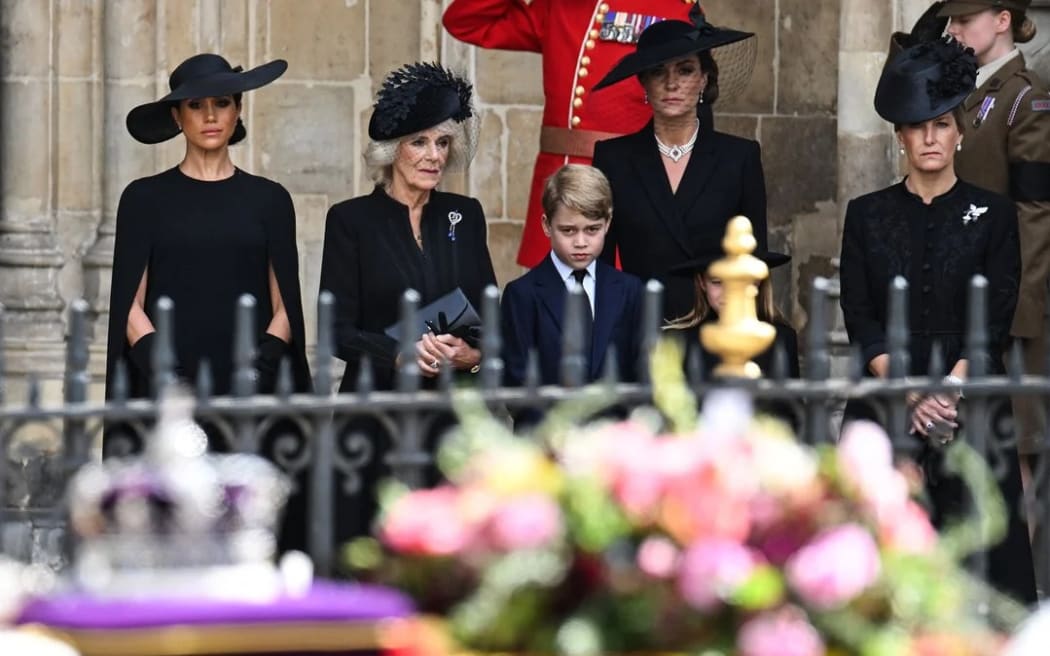 Meghan, Duchess of Sussex, Camilla, Queen Consort, Prince George of Wales, Catherine, Princess of Wales and Sophie, Countess of Wessex look at the coffin of Queen Elizabeth II as they leave Westminster Abbey in London.