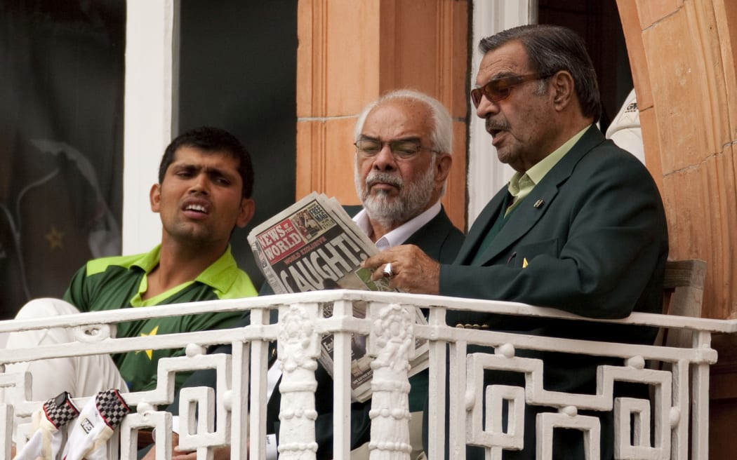 Pakistan manager Yawar Saeed (right), Assistant Manager Shafqat Rana and Kamran Akmal (left) reading the News of the World on the team's dressing room balcony after it broke the match fixing scandal during the final Test Match against England at Lord's in 2010.