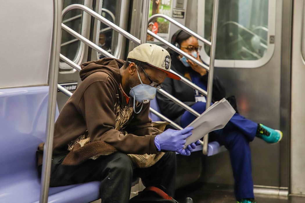 New York metro passengers and staff are visas wearing protective masks during the COVID-19 coronavirus pandemic in the United States.