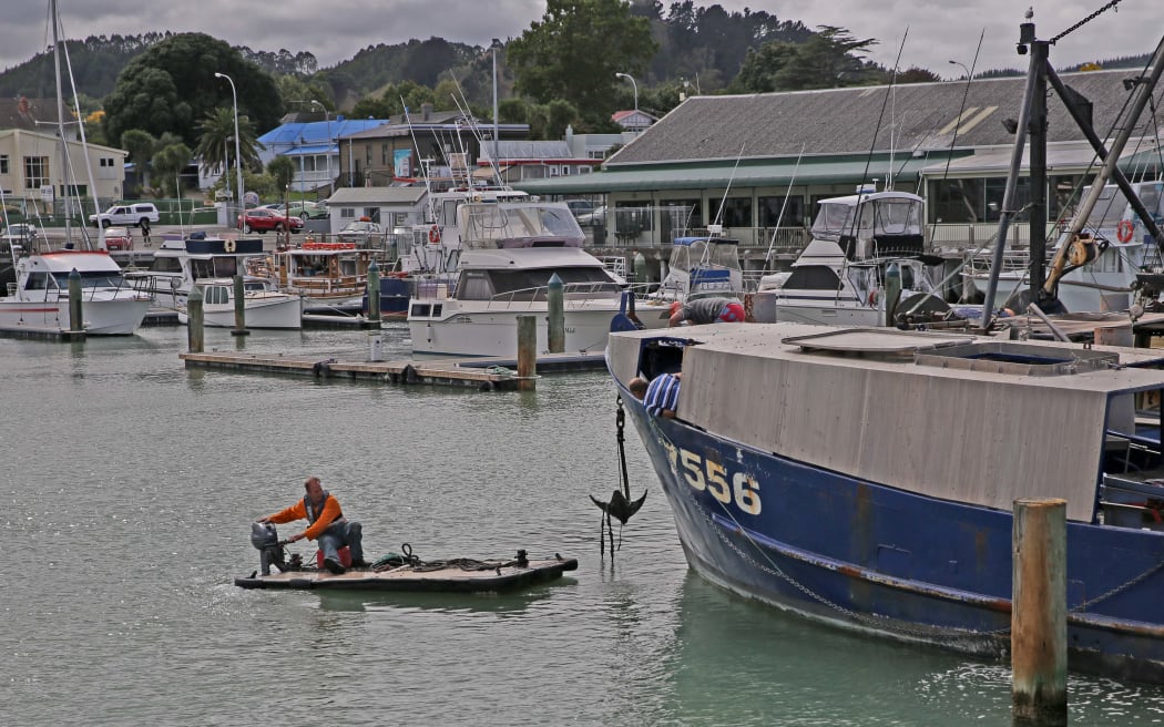 Positioning  their fishing boat for the king tide expected to hit Gisborne around 6pm