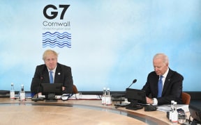 Britain's Prime Minister Boris Johnson (L) and US President Joe Biden sit around the table at the start of the G7 summit in Carbis Bay, Cornwall on 11 June 2021.