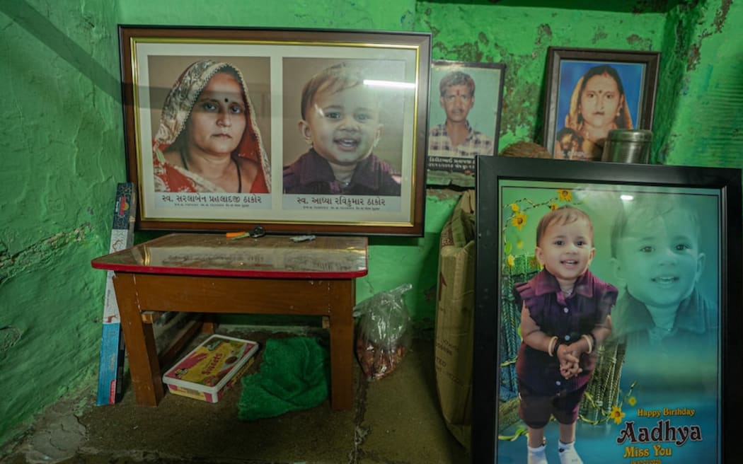 Framed photographs in the Thakor home, in tribute to Aadhya and Sarla Ben Thakor, who were killed in the crash.