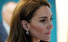 Britain's Catherine, Princess of Wales, listens to staff during a visit to the Open Door Charity, a charity focused on supporting young adults across Merseyside with their mental health, using culture and creativity as the catalyst for change in Birkenhead on January 12, 2023.