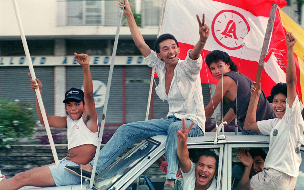 Residents of Panama City erupt into celebration on the streets following the anouncement that Panamanian General Manuel Noriega has sought asylum in the Vatican Embassy, on December 24, 1989. On December 20, 1989, The US army invaded the country during "Operation just cause" to remove Panama's General Manuel Antonio Noriega from power and bring him to the US for trial on drug charges. (Photo by JONATHAN UTZ / AFP)