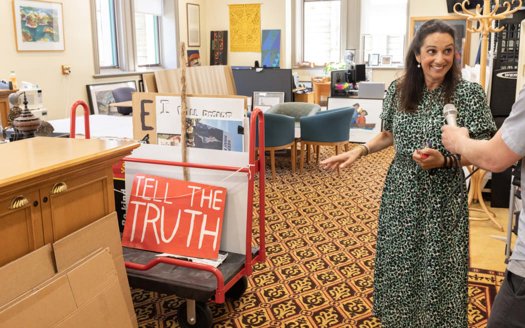 Parliamentary Curator Tash Fernandez shows Johnny Blades some of the protest signs she collected after the occupation of Parliament's lawn. These items are part of the Parliamentary Collection.
