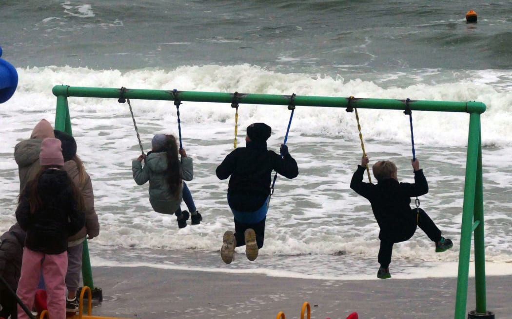 ODESA, UKRAINE - NOVEMBER 6, 2022 - Children are seen on the swings as a storm hits the Black Sea coast of Odesa, southern Ukraine.NO USE RUSSIA. NO USE BELARUS. (Photo by Yulii Zozulia / NurPhoto / NurPhoto via AFP)