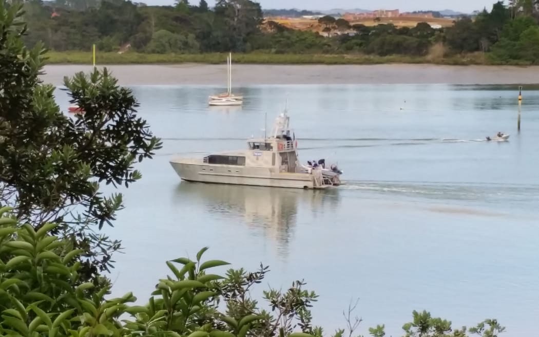A police boat takes part in the search for the missing swimmer