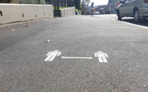 2 metre distance signs on Auckland footpaths on day one of alert level 3 on 28 April.