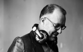 Peter Urlich wearing headphones around his neck
