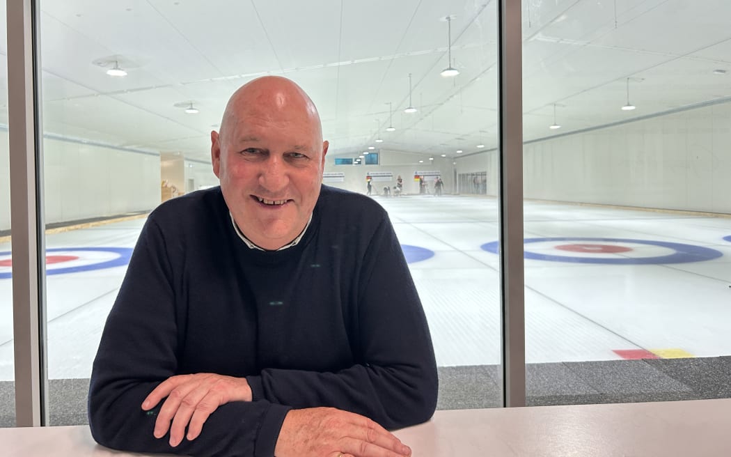 Picture shows a man smiling at the camera.