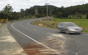 Oil and absorbent grit spread by firefighters mark the spot where a station wagon and a van collided in April 2018 at the bottom of Bulls Gorge, on SH10 near Kerikeri, with fatal consequences.