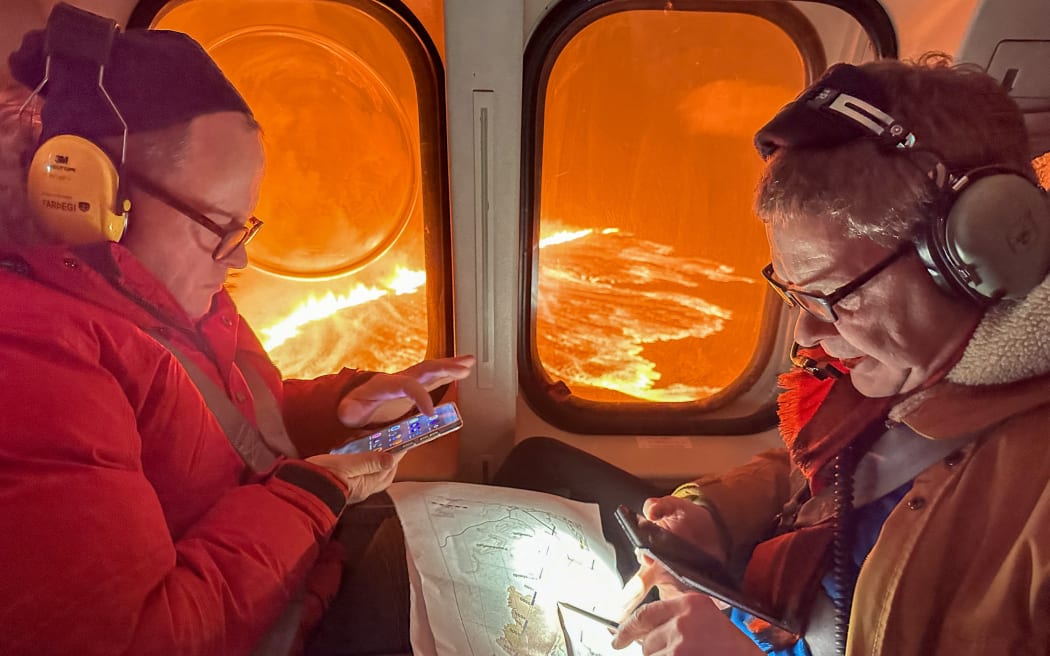 This handout picture released by the Icelandic Coast Guard on March 16, 2024 shows billowing smoke and flowing lava pouring out of a new fissure, during a surveilance flight above a new volcanic eruption on the outskirts of the evacuated town of Grindavik, western Iceland. A volcanic eruption started on the Reykjanes peninsula in southwestern Iceland on Thursday, the third to hit the area since December, authorities said. (Photo by HANDOUT / Icelandic Coast Guard / AFP) / RESTRICTED TO EDITORIAL USE - MANDATORY CREDIT "AFP PHOTO /HANDOUT/ICELANDIC COAST GUARD " - NO MARKETING - NO ADVERTISING CAMPAIGNS - DISTRIBUTED AS A SERVICE TO CLIENTS