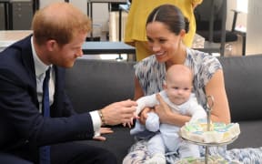 Britain's Duke and Duchess of Sussex, Prince Harry and his wife Meghan hold their baby son Archie as they meet with Archbishop Desmond Tutu (unseen) at the Tutu Legacy Foundation  in Cape Town on September 25, 2019.