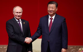 In this pool photograph distributed by the Russian state agency Sputnik, Russia's President Vladimir Putin and China's President Xi Jinping attend a concert marking the 75th anniversary of the establishment of diplomatic relations between Russia and China and opening of China-Russia Years of Culture at the National Centre for the Performing Arts in Beijing on May 16, 2024. (Photo by Alexander RYUMIN / POOL / AFP) / ** Editor's note : this image is distributed by Russian state owned agency Sputnik **