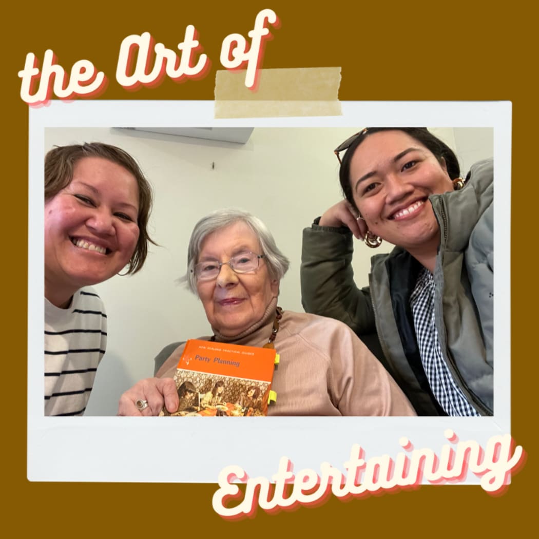 Two young women pose with the author of Party Planning, a guide to entertaining. The author, Jacqueline Steincamp is holding up her book, published in 1973.  The image has been framed using 70s colouring and is captioned "The Art of Entertaining".