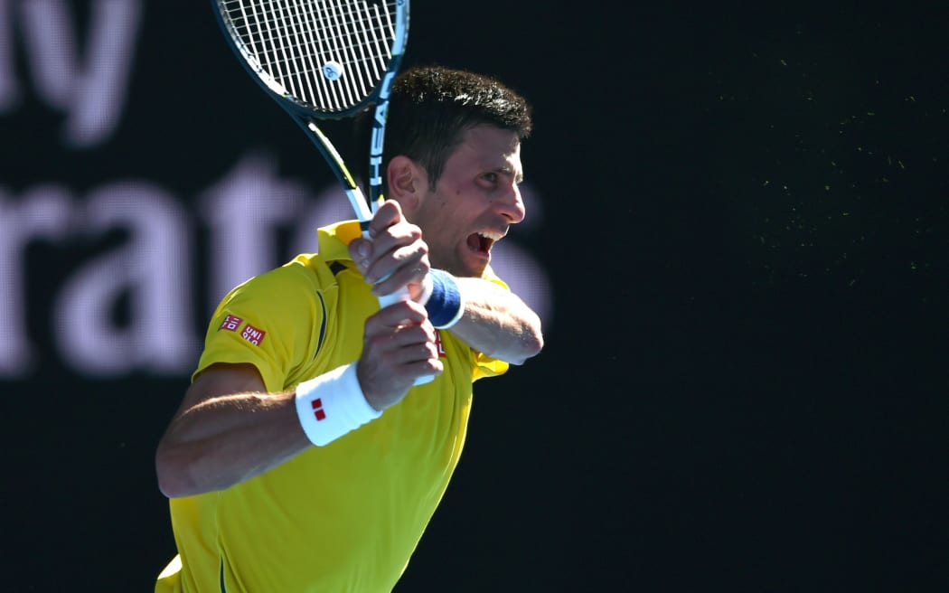Serbia's Novak Djokovic as he fought against France's Gilles Simon on day seven of the 2016 Australian Open in Melbourne on January 24, 2016. AFP PHOTO / PETER PARKS