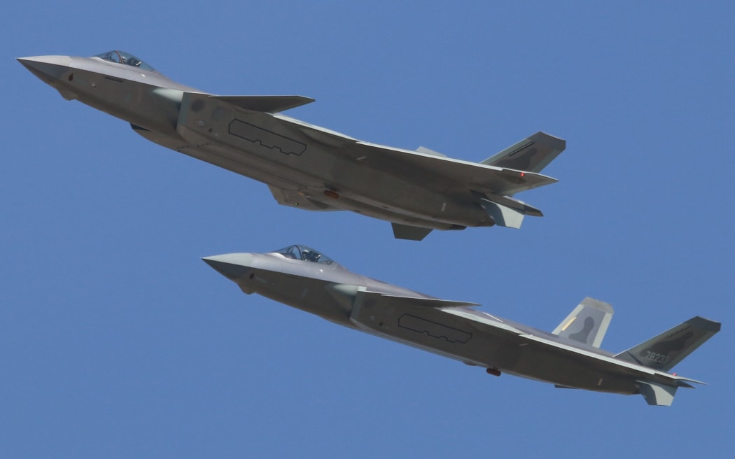 J-20 stealth fighter jets of the Chinese PLA (People's Liberation Army) Airforce fly during a training session in preparation for the 12th China International Aviation and Aerospace Exhibition, also known as Airshow China 2018, in Zhuhai city, south China's Guangdong province, 30 October 2018.