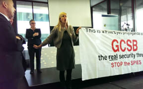 Una Jagose is prevented from speaking by protesters.