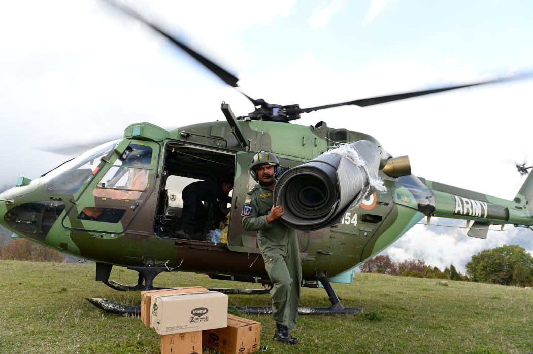 An Indian Air Force (IAF) helicopter pilot unloads relief aid in the village of Laprak.