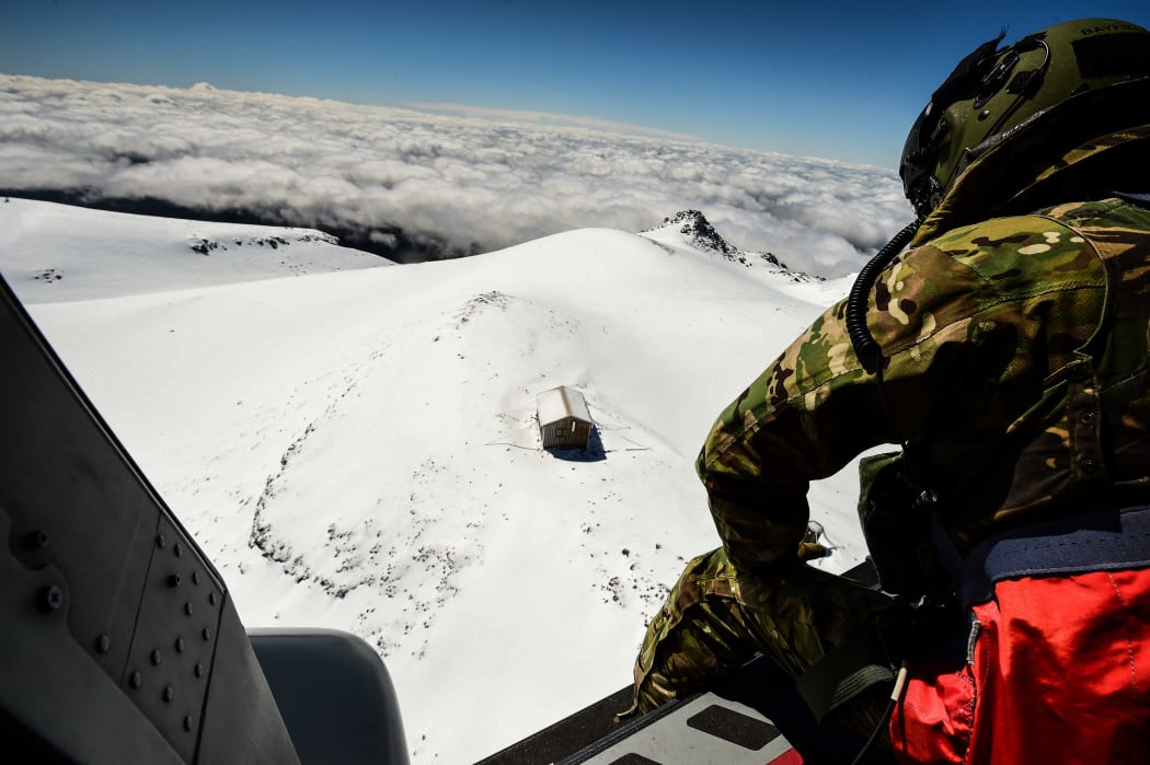A crew member looks down at Syme Hut on Mt Taranaki, where a 29-year-old Dutch tramper spent two freezing nights before being rescued by the Air Force.