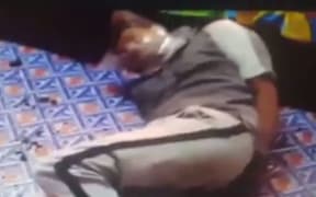 A screenshot of video showing Rajneel Singh in Fiji lying on the floor of his home during an attack. The video has been confirmed as genuine by his lawyer Aman Ravindra-Singh.