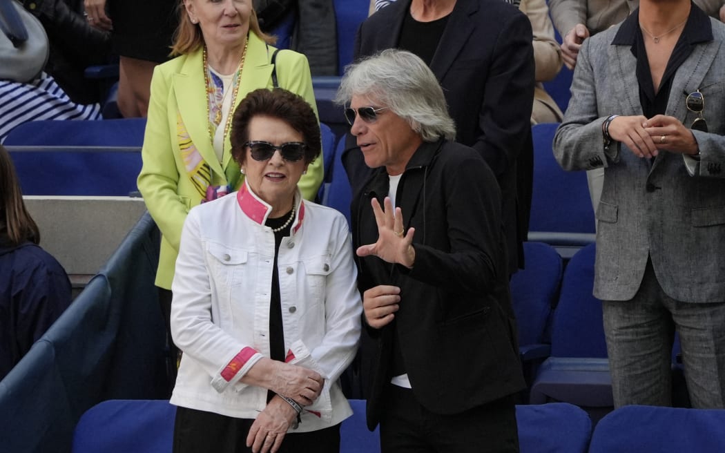 (L-R) US former tennis player Billie Jean King talks with US musician Jon Bon Jovi during the men's final match on day fourteen of the US Open tennis tournament at the USTA Billie Jean King National Tennis Center in New York City, on September 8, 2024. (Photo by TIMOTHY A. CLARY / AFP)