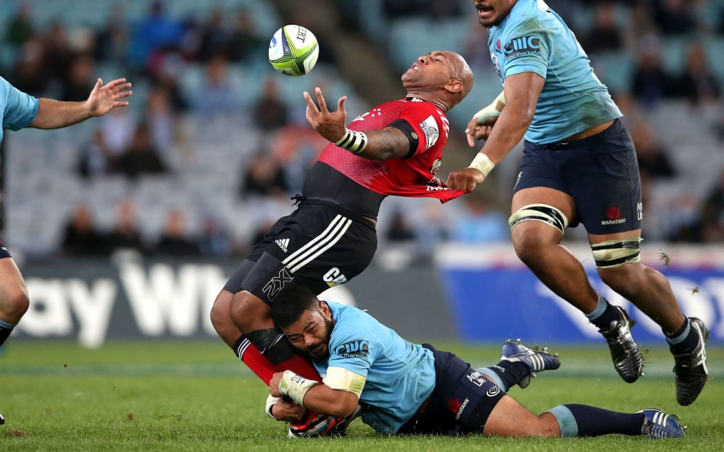 Nemani Nadolo is bent backwards under the tackle of Tolu Latu.