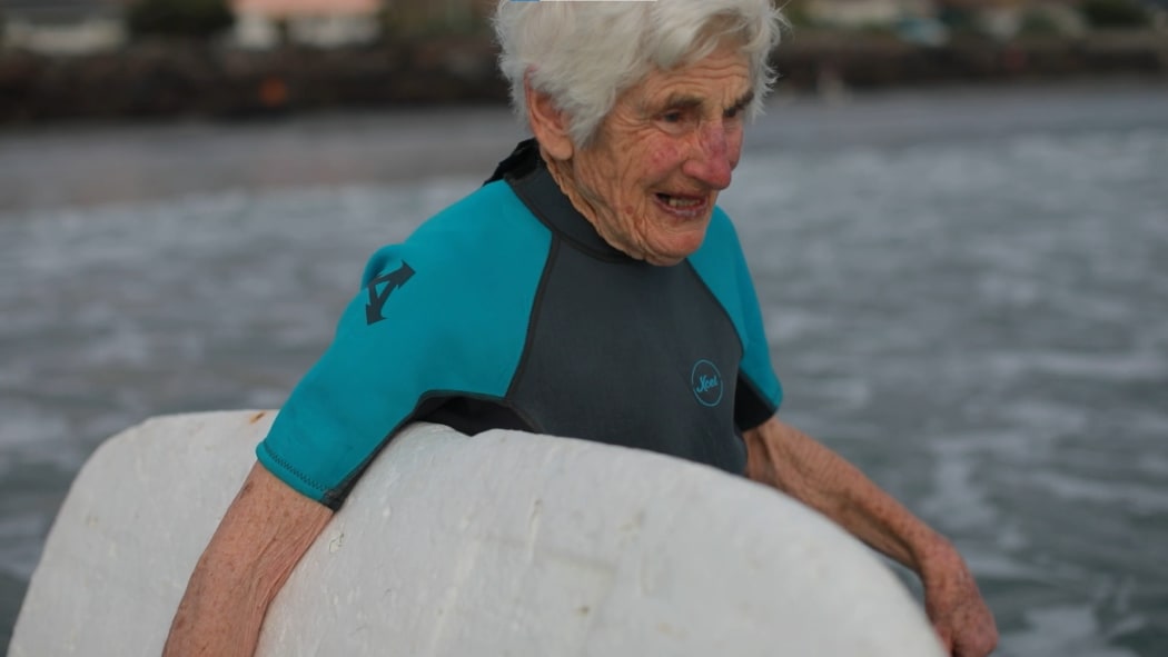 92-year-old surfer Nancy Meherne heads out to catch some waves