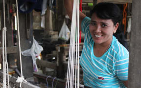 Cing Din Nuam, a weaver who's business has been supported by microfinance.