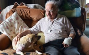 Jim Morgan comforts his dog Sandy, which was attacked on the weekend.